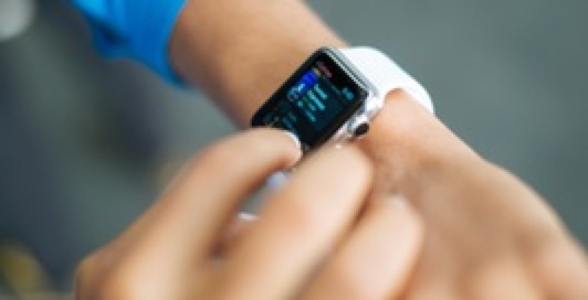 Someone interacting with their smartwatch