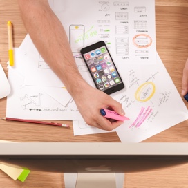 Topdown view of a busy desk workspace